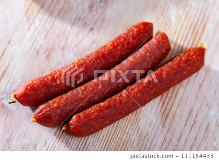 Appetizing tyrolean sausages on wooden table 111154433