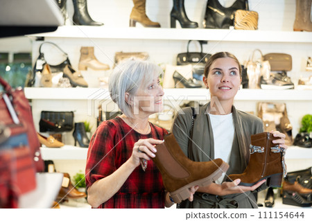 Two women are shopping in shoe store 111154644