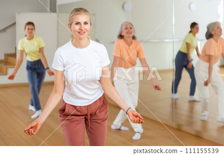Woman dancing during group class 111155539