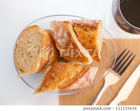 Sliced french baguette on plate in restaurant Sliced french baguette on plate in restaurant 111155634