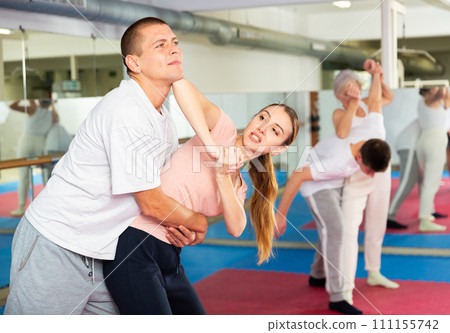 Woman and man practicing self defense techniques Woman and man practicing self defense techniques 111155742