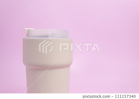 Closeup Travel Coffee Beige Mug, Thermo Hot Coffee Tumbler, Cropped Reusable Tea Mug with Seal Lid, Buckle, Vacuum Stainless Steel Cup on Pink Background, Mockup. Copy Space. Cold or Hot Beverages Closeup Travel Coffee Beige Mug, Thermo Hot Coffee Tumbler, Cropped Reusable Tea Mug with Seal Lid, Buckle, Vacuum Stainless Steel Cup on Pink Background, Mockup. Copy Space. Cold or Hot Beverages 111157340