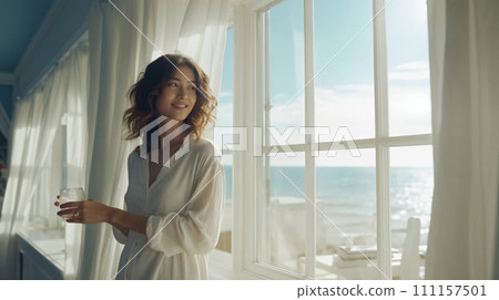 Relaxed healthy woman looking out the window 111157501