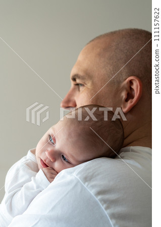 A newborn baby lies on his father's shoulder. Close-up. Caring concept 111157622