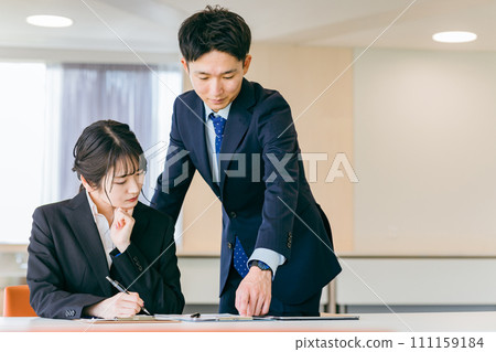 Business woman attending seminar/training/information session/study session and businessman instructor (coaching) 111159184