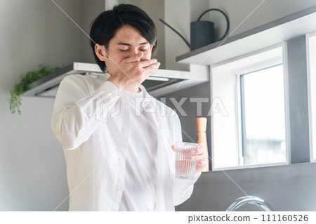 Sick man taking oral medicine, supplements, and medicines in the kitchen / Medication Sick man taking oral medicine, supplements, and medicines in the kitchen / Medication 111160526