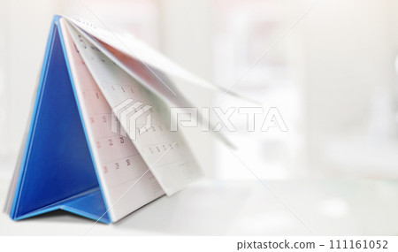 desk calendar on table with blurred bokeh background appointment and business meeting concept 111161052