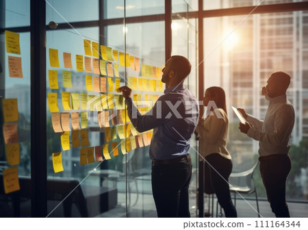 Business people meeting at office and use post it notes to share idea. Brainstorming concept. Sticky note on glass wall Business people meeting at office and use post it notes to share idea. Brainstorming concept. Sticky note on glass wall 111164344