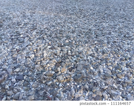 The ground of a monthly parking lot paved with pebbles The ground of a monthly parking lot paved with pebbles 111164657