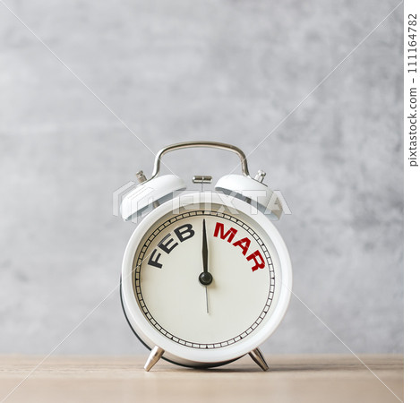 Hello March Changed from February  month with vintage alarm clock on table background. Calendar, Monthly, New Start, Resolution, Goals, Plan, Action and Mission Concept 111164782