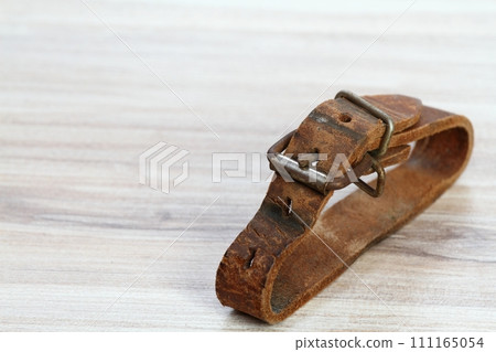 Old leather straps used to tie up skis togetner Old leather straps used to tie up skis togetner 111165054
