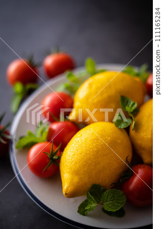 fresh lemon and cherry tomatoes fresh lemon and cherry tomatoes 111165284