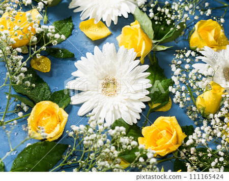 Floral background with yellow and white flowers on blue Floral background with yellow and white flowers on blue 111165424