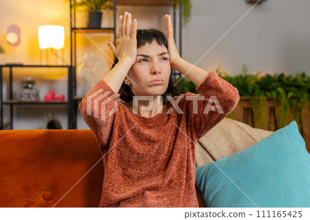 Woman rubbing temples to cure headache problem suffering from tension and migraine stress pain Woman rubbing temples to cure headache problem suffering from tension and migraine stress pain 111165425