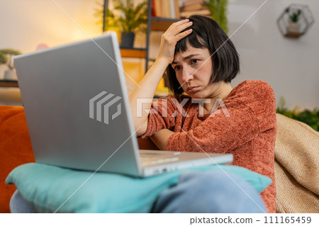 Angry woman using laptop working, loses becoming surprised sudden lottery results bad news loss fail Angry woman using laptop working, loses becoming surprised sudden lottery results bad news loss fail 111165459
