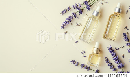 Elegant flat lay of body oils and perfume bottles with lavender sprigs on a pastel background, minimalist style Elegant flat lay of body oils and perfume bottles with lavender sprigs on a pastel background, minimalist style 111165554