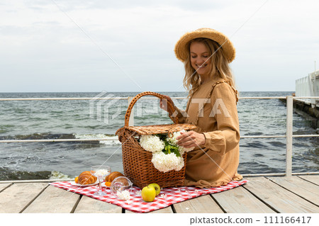 The concept of a picnic by the sea, with flowers. 111166417