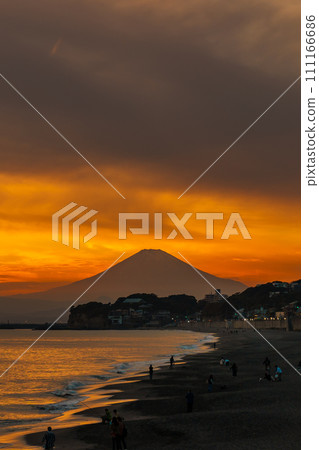 Scenery Kamakura Yuigahama Beach with Kamakura city and Fujisan mountain. Twilight silhouette Mount Fuji behind Enoshima island at Kamakura, Kanagawa, Japan. Landmark for tourist attraction near tokyo Scenery Kamakura Yuigahama Beach with Kamakura city and Fujisan mountain. Twilight silhouette Mount Fuji behind Enoshima island at Kamakura, Kanagawa, Japan. Landmark for tourist attraction near tokyo 111166686
