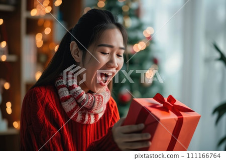 A woman is delighted and surprised to receive a gift box, online shopping and delivery A woman is delighted and surprised to receive a gift box, online shopping and delivery 111166764