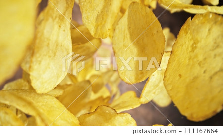 Flying Fried Potato Chips Levitating in the Air. Concept of Flying Junk Food. Selective Focus. 111167664