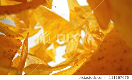 Flying Fried Tortilla Chips Levitating in the Air. Concept of Flying Junk Food. Flying Fried Tortilla Chips Levitating in the Air. Concept of Flying Junk Food. 111167676