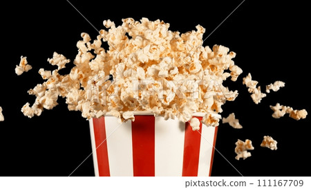 Popcorn Flying up in the Air from Paper Bucket. Popcorn Flying up in the Air from Paper Bucket. 111167709