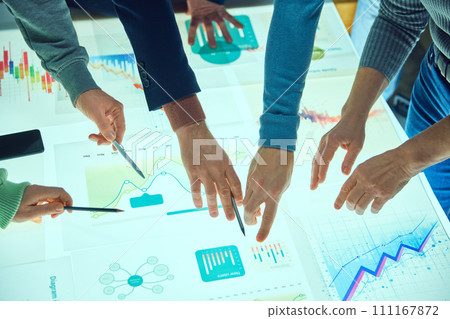 Project managers, business people working with digital table, checking analytics, chats statistics and data. Discussing further strategy for company development 111167872