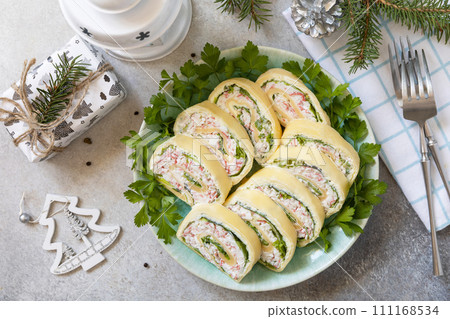 Creative appetizers christmas. Cheese roll with crab sticks, cream cheese and eggs. View from above. 111168534