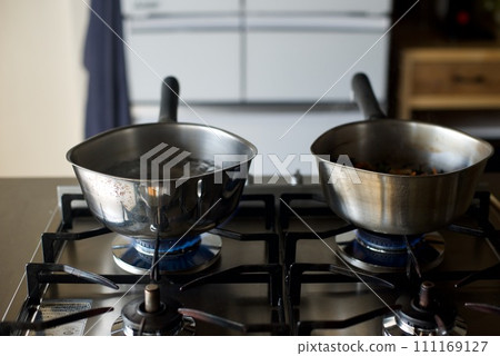 Boiling water in a hand pot Boiling water in a hand pot 111169127