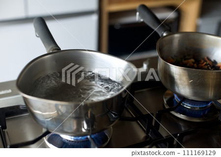 Boiling water in a hand pot Boiling water in a hand pot 111169129