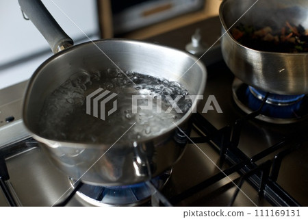 Boiling water in a hand pot Boiling water in a hand pot 111169131