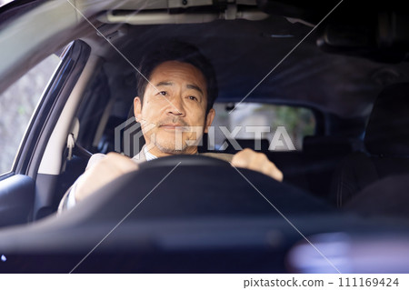 Businessman driving a car 111169424