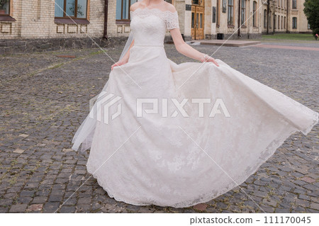 bride with a bouquet of flowers in the park 111170045