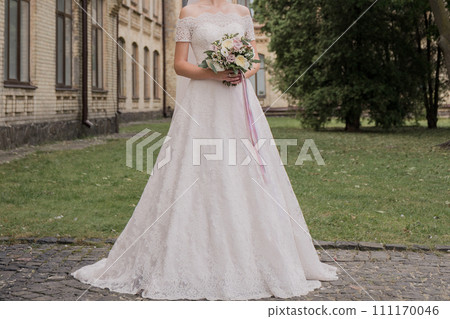 bride with a bouquet of flowers in the park 111170046