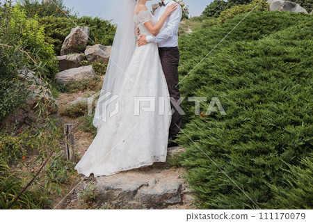 bride and groom in summer park together 111170079