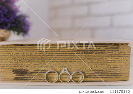 wedding rings near a book on the table wedding rings near a book on the table 111170380