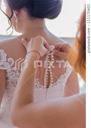 the bride wears a wedding dress 111170405