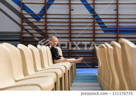A gymnast girl sitting in the auditorium A gymnast girl sitting in the auditorium 111170735