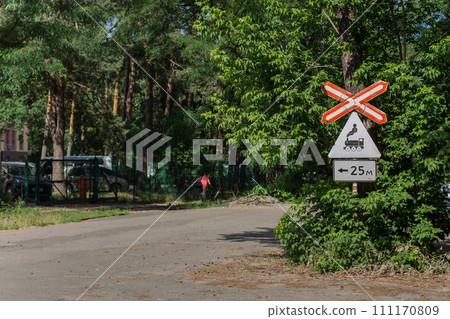 railway crossing sign on the road 111170809