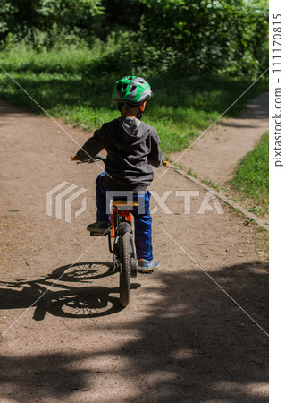 boy in a helmet on a bicycle in the park boy in a helmet on a bicycle in the park 111170815