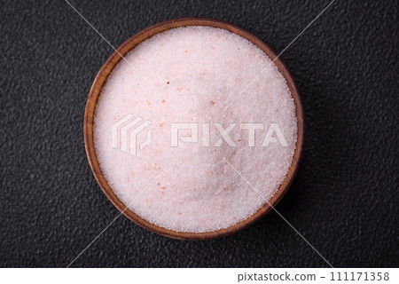 Fine pink Himalayan table salt in a ceramic bowl 111171358