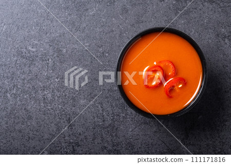 Spicy chili sauce in bowl on black background. Spicy chili sauce in bowl on black background. 111171816