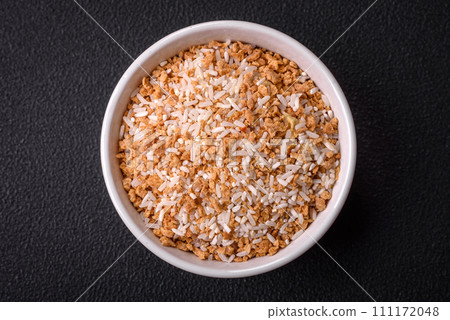 Large grains of uncooked white rice in a ceramic bowl Large grains of uncooked white rice in a ceramic bowl 111172048