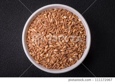 Large grains of wheat porridge are brown in color when raw Large grains of wheat porridge are brown in color when raw 111172067