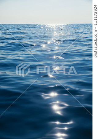 Tranquil sea with glistening sun reflection natural background Tranquil sea with glistening sun reflection natural background 111172924