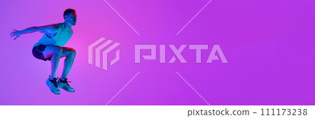 Athletic man in sportswear training, jumping against gradient pink background in neon light Athletic man in sportswear training, jumping against gradient pink background in neon light 111173238