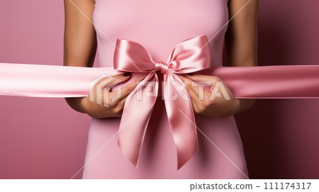 World Cancer Day, breast cancer awareness, Hands catching a pink bow on a pink background, AI Generative 111174317