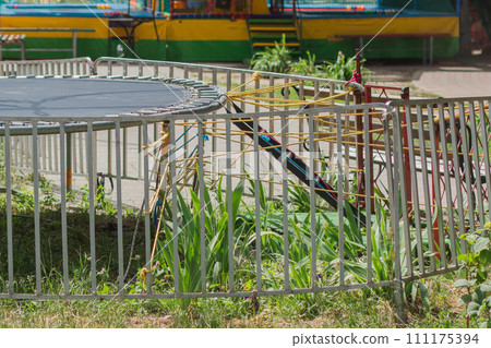 empty trampoline in children park 111175394