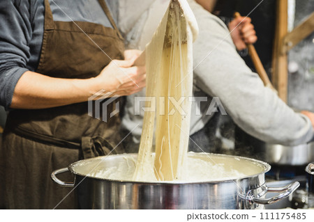 Baker kneads dough on the market 111175485