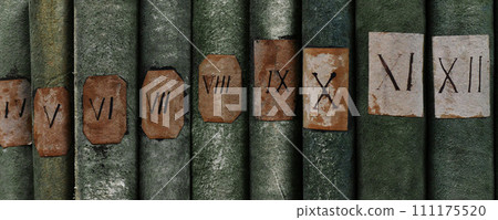 Old books with Roman numerals in the library 111175520